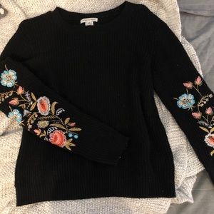 Black sweater with embroidered sleeves